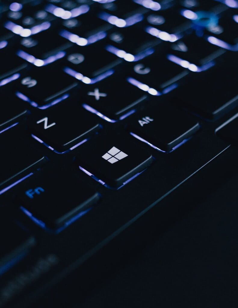 A black keyboard with a pale purple backlight.