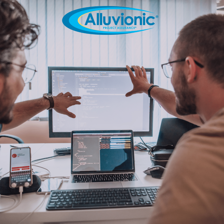 Two professionals collaborating at a workstation, on multiple screens with the Alluvionic logo in the background.