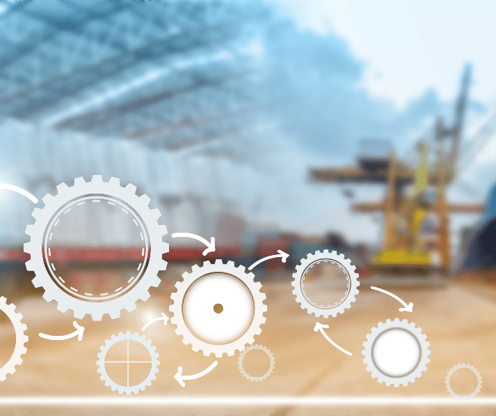 Large equipment under a fabric roofed structure with white gear graphics in the forefront.