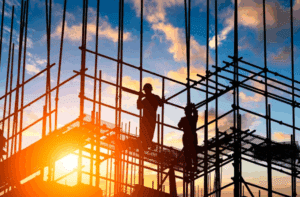 Construction workers with a colorful sunset in the background