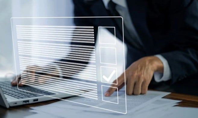 Businessperson working with documents and laptop, overlaid with a digital checklist and check mark
