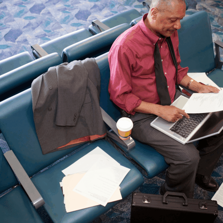 Man working in airport on laptop