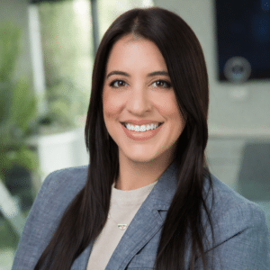 Lauren De Leon, Project Manager at Alluvionic, smiling in a professional office headshot.
