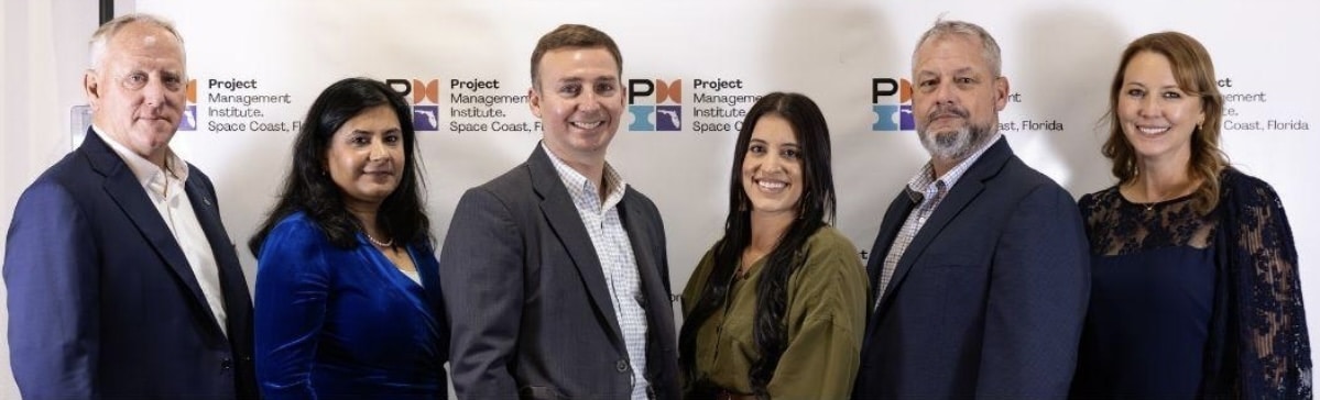 Group of professionals posing together at a PMI Space Coast Chapter awards event.